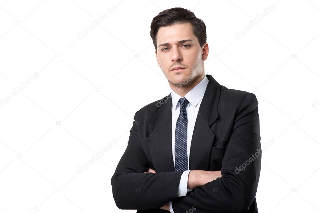 young serious businessman in black suit, isolated on white background
