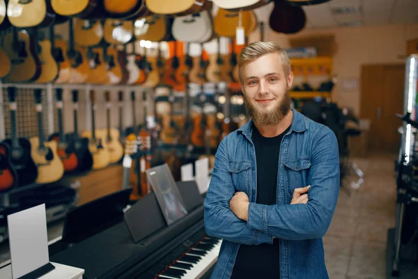 Jongeman Poseert Bij Showcase Muziekwinkel Assortiment Muziekinstrumentenwinkel Muzikant Die Apparatuur — Stockfoto