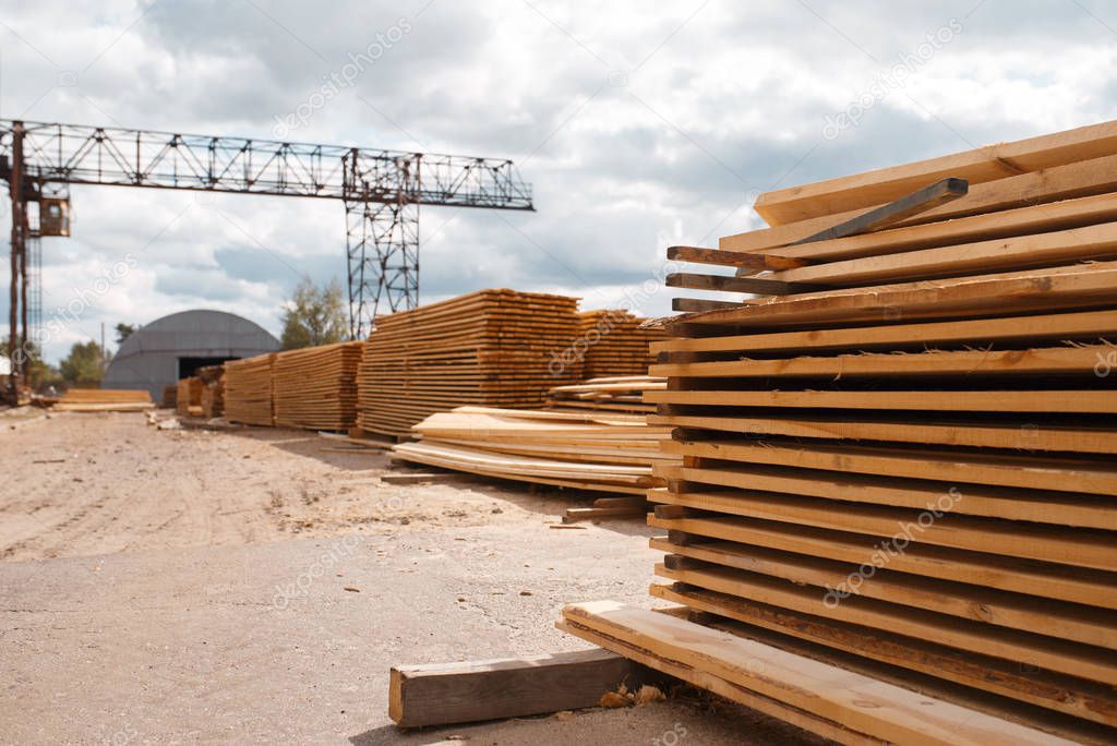 Boards on timber mill warehouse outdoor, nobody, lumber industry, carpentry. Wood processing on factory, forest sawing in lumberyard, sawmill