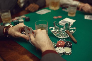 Poker oyuncuları kumarhanede kart ve çiplerle masada oturuyorlar. Şans oyunları, kumar oyunları., 