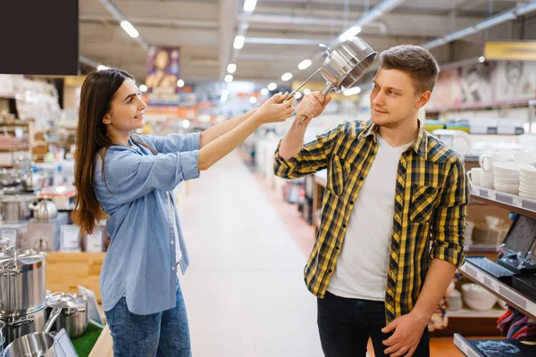 Fiatal Pár Viccek Merőkanállal Serpenyővel Háztartási Boltban Férfi Vásárol Otthon — Stock Fotó