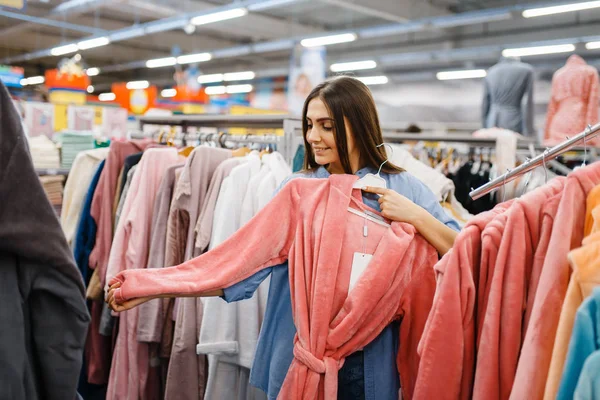 Young Woman Choosing Bathrobe Bed Linen Store Female Person Buying — 스톡 사진