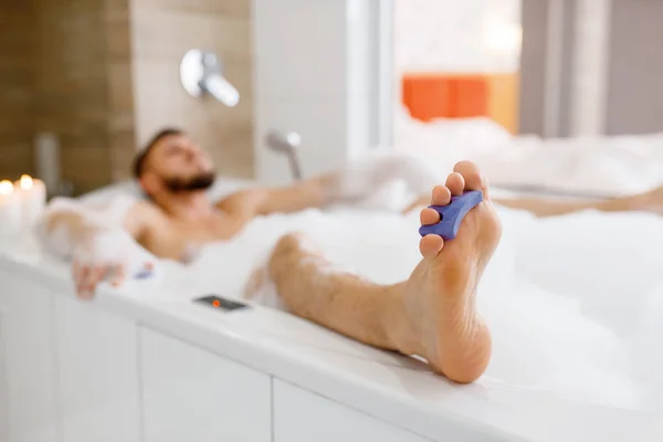 男は朝泡風呂に寝そべっている 男性はバスルーム 皮膚やボディトリートメントの手順でリラックス — ストック写真