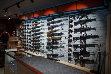 Rifle choice, showcase in gun shop, nobody. Euqipment for hunters on stand in weapon store, hunting and sport shooting hobby  clipart