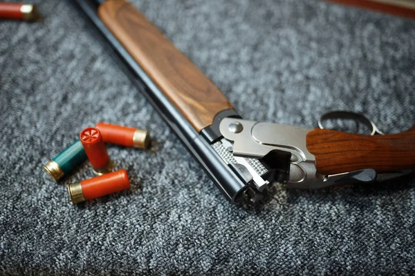 Rifle and ammo in gun shop, closeup, nobody. Euqipment for hunters on stand in weapon store, hunting and sport shooting hobby