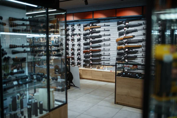 Rifle choice, showcase in gun shop, nobody. Euqipment for hunters on stand in weapon store, hunting and sport shooting hobby