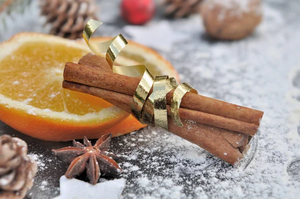 Stick of cinnamon in golden ribbon — Stock Photo, Image