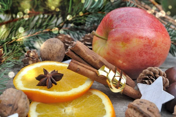 Stick of cinnamon in golden ribbon with fruits — Stock Photo, Image