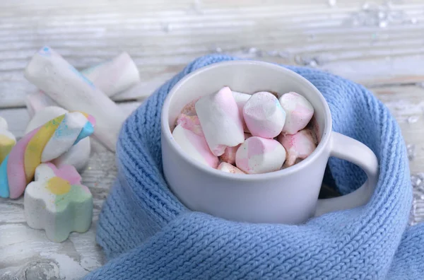 A mug full of marshmallow in milk chocolate on a blue child scar — Stock Photo, Image
