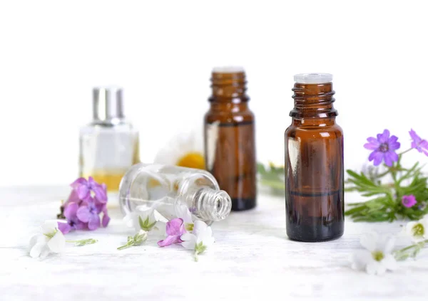 Bottles Essential Oil Colorful Petals Flowers White Table White Background — Stock Photo, Image