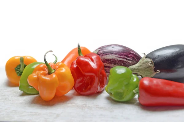 Group Colorful Hot Peppers Eggplant Table White Background — Stock Photo, Image