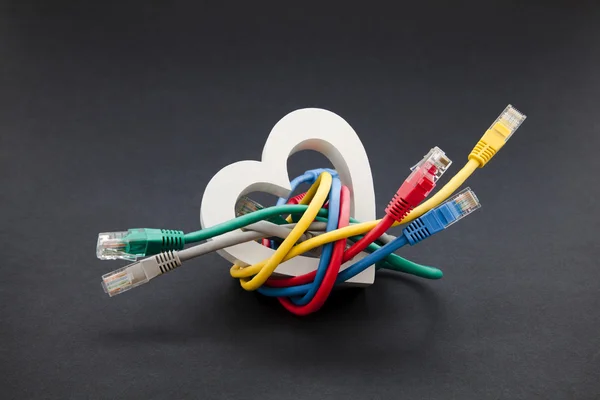 Online love and social networking concept. Network cables with heart shape — Stock Photo, Image