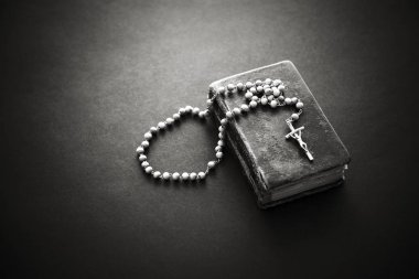 Rosary on the old Bible  clipart
