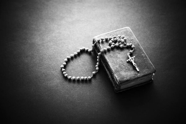 Rosary on the old Bible 