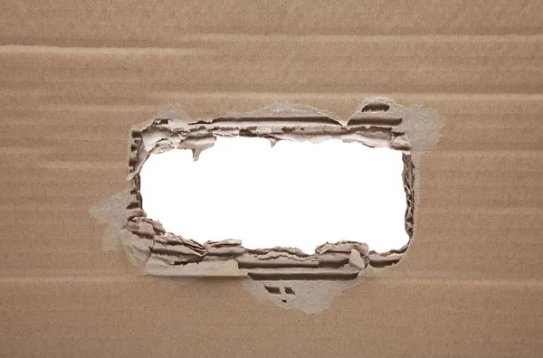 Ripped hole in cardboard on white background with clipping path — Stock Photo, Image