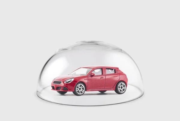 Red car protected under a glass dome — Stock Photo, Image