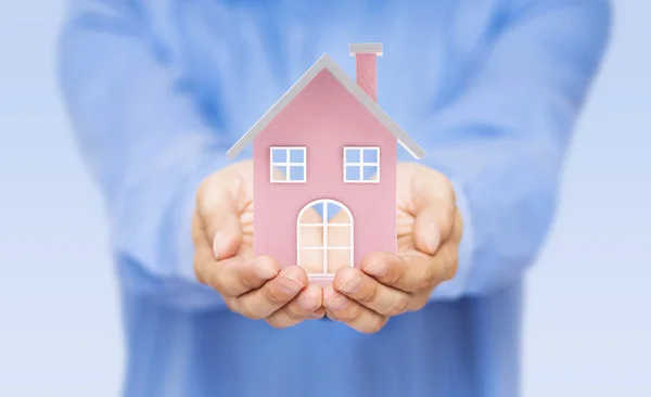 Small pink toy house in hands — Stock Photo, Image
