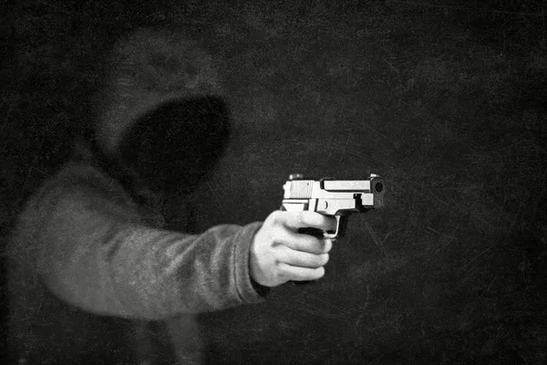 Ghostly figure with a gun in the dark — Stock Photo, Image
