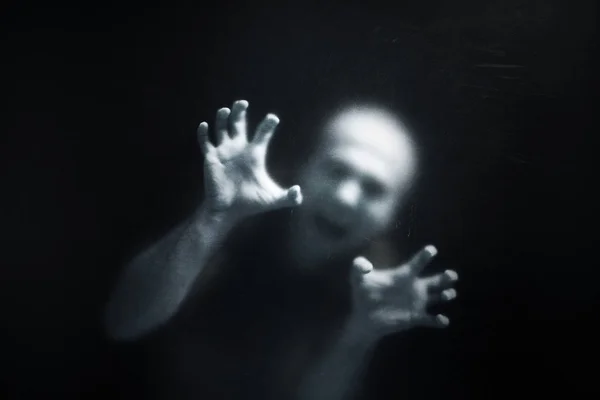 Screaming man behind a dusty scratched glass — Stock Photo, Image