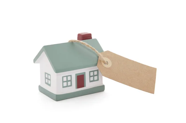 Little house with blank tag tied with string on white background — Stock Photo, Image