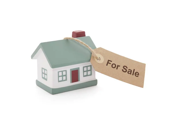 Little house with for sale tag tied with string on white background — Stock Photo, Image