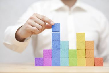 Renkli ahşap bloklar istifleme elini. İş geliştirme kavramı 