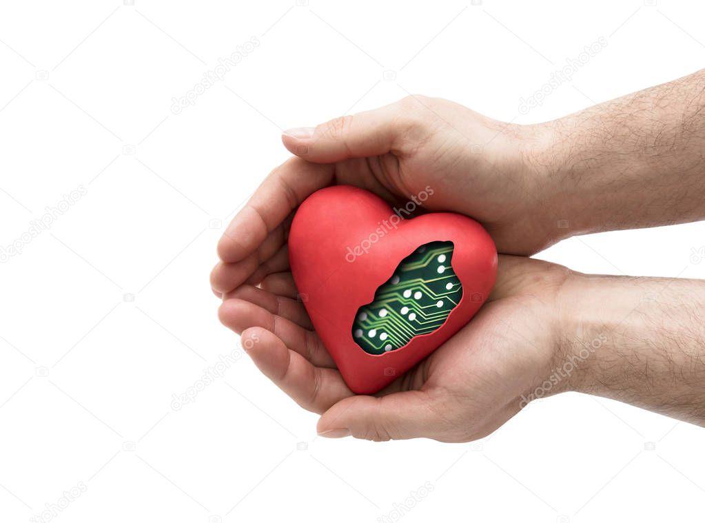 Red computer heart in hands isolated on white with clipping path 