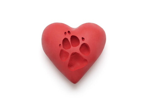 Red heart with dog paw print over white background with clipping path 