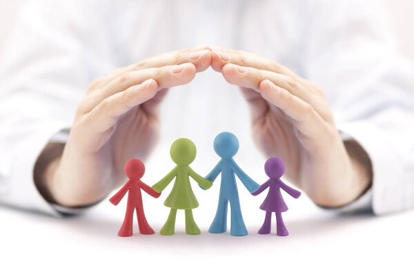 Family insurance concept with colorful family figurines covered by hands