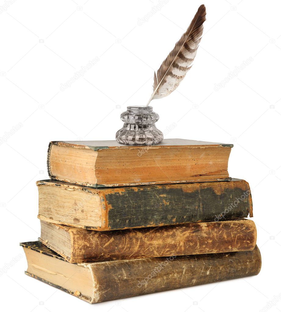 Isolated inkwell, quill and old books