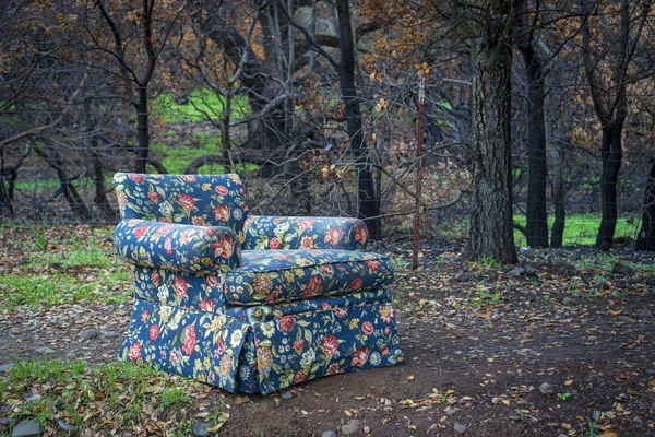 Abandoned floral fabric chair — Stock Photo, Image