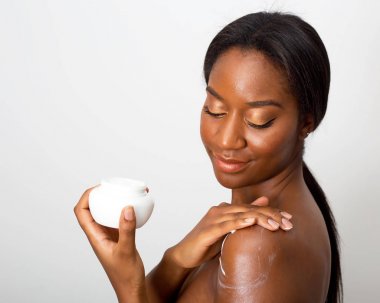 african american beauty applying moisturizing cream clipart