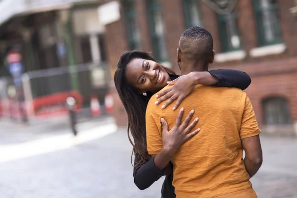 young couple hugging in the street