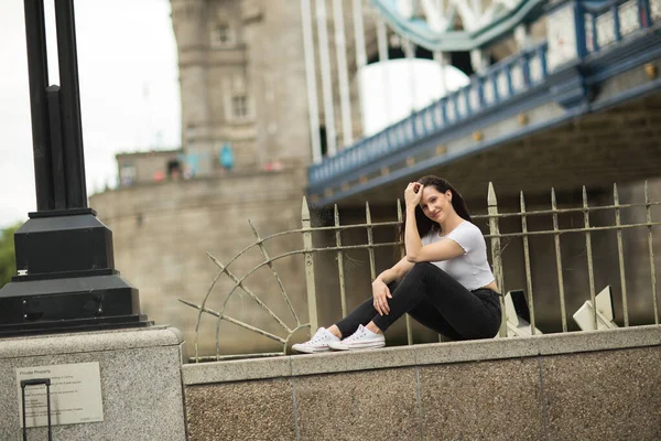 Young Woman Sitting Wall Tower Bridge — Stock Photo, Image