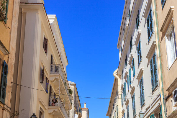 KERKYRA, CORFU, GREECE - Mart 4 2017: Tourists walking and shopping on narrow streets in the historical Kerkyra city center in Corfu near the Cathedral of St. Spyridon of Trimythous