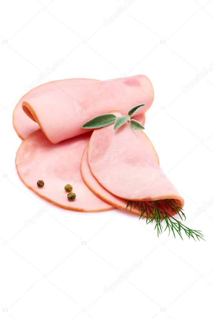 Cooked boiled ham sausage or rolled bologna slices isolated on white background with herbs and spices