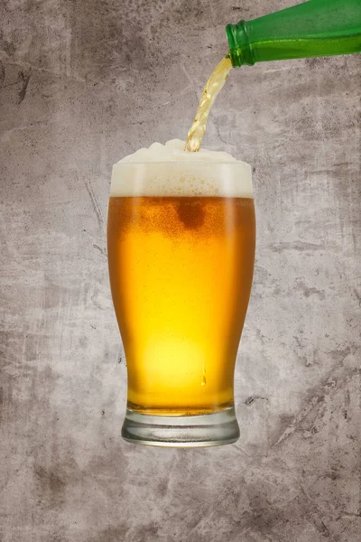 Beer splash in glass on vintage background with copy space — Stock Photo, Image