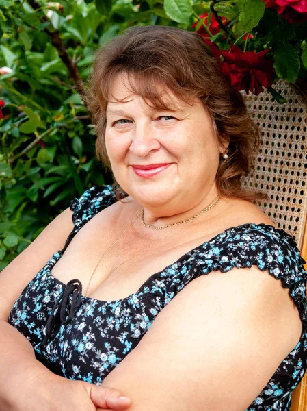 Mature plump woman in Park smiling and looking at the camera