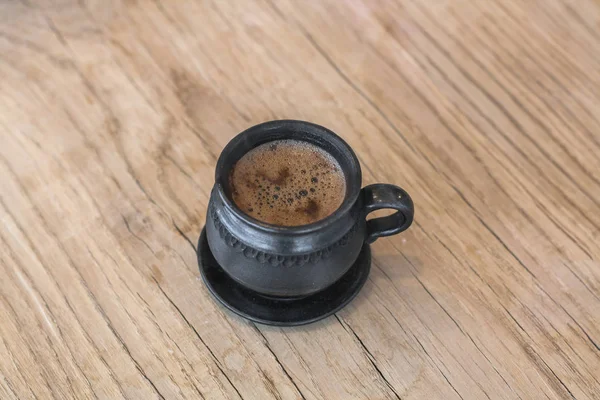 Kil kahve Kupası ahşap bir masa üzerinde