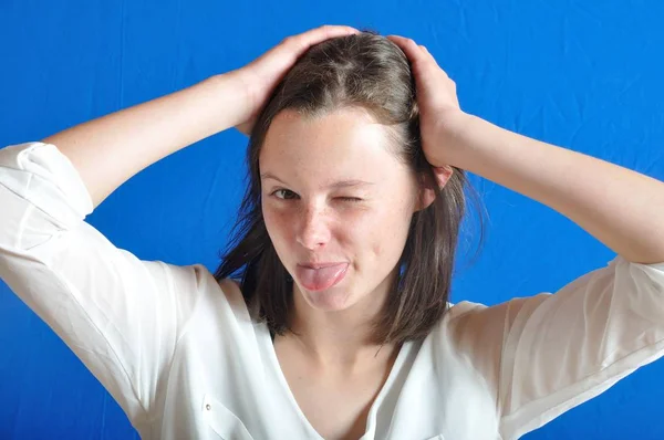 Young girl sticking out her tongue — Stock Photo, Image