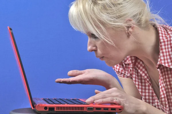 Woman blowing a kiss with notebook computer — Stock Photo, Image