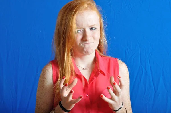 Irritated teen on blue background — Stock Photo, Image