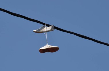 Shoes tied onto a powerline clipart