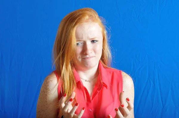 Irritated teen on blue background — Stock Photo, Image