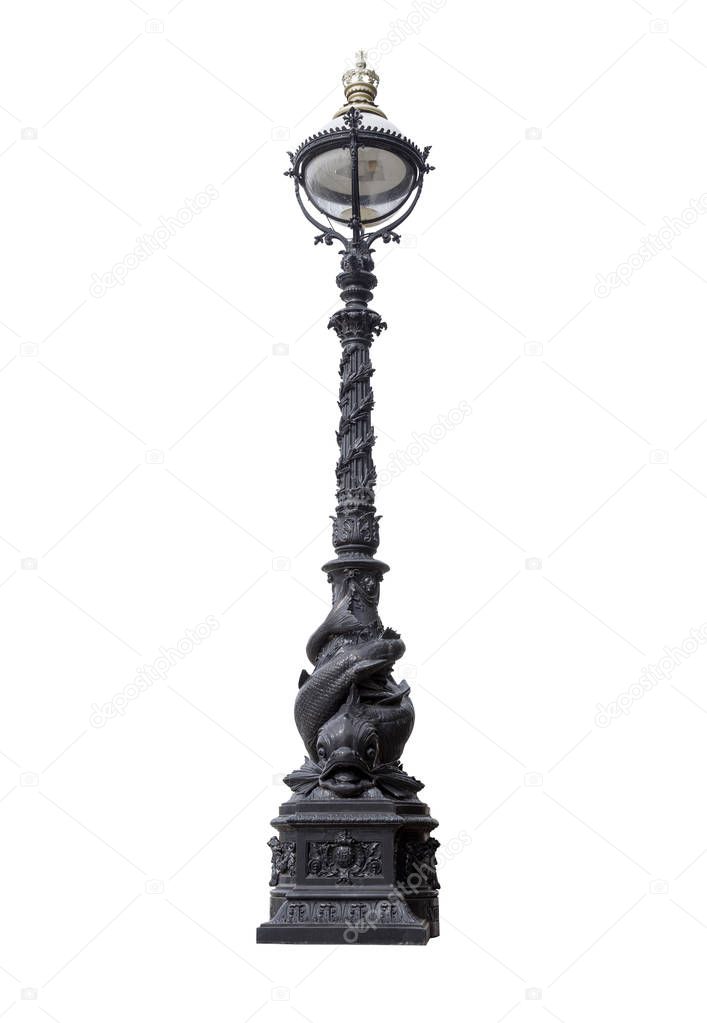 Old London dolphin lamp post isolated on white