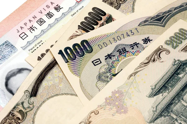 Japanese visa in a passport and Japanese currency