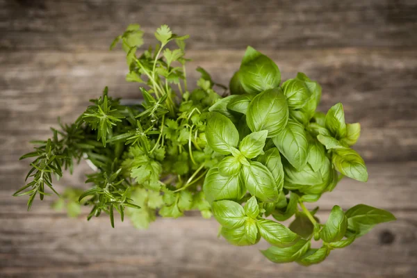Fresh herbs on old wood background — Stock Photo, Image
