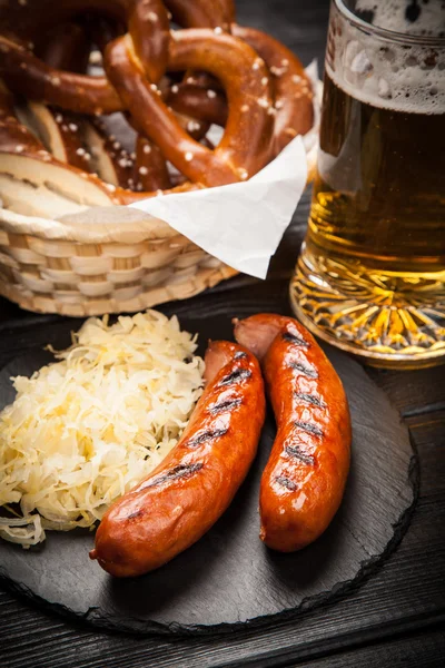 Pretzels, bratwurst and sauerkraut — Stock Photo, Image