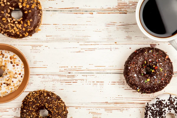 Tasty donuts on white wood background — Stock Photo, Image