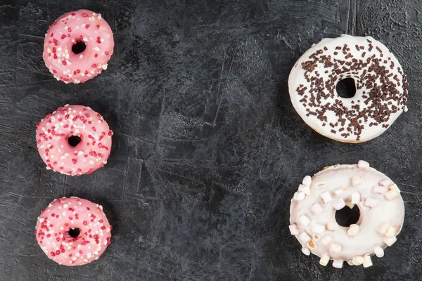 Tasty donuts on dark background — Stock Photo, Image